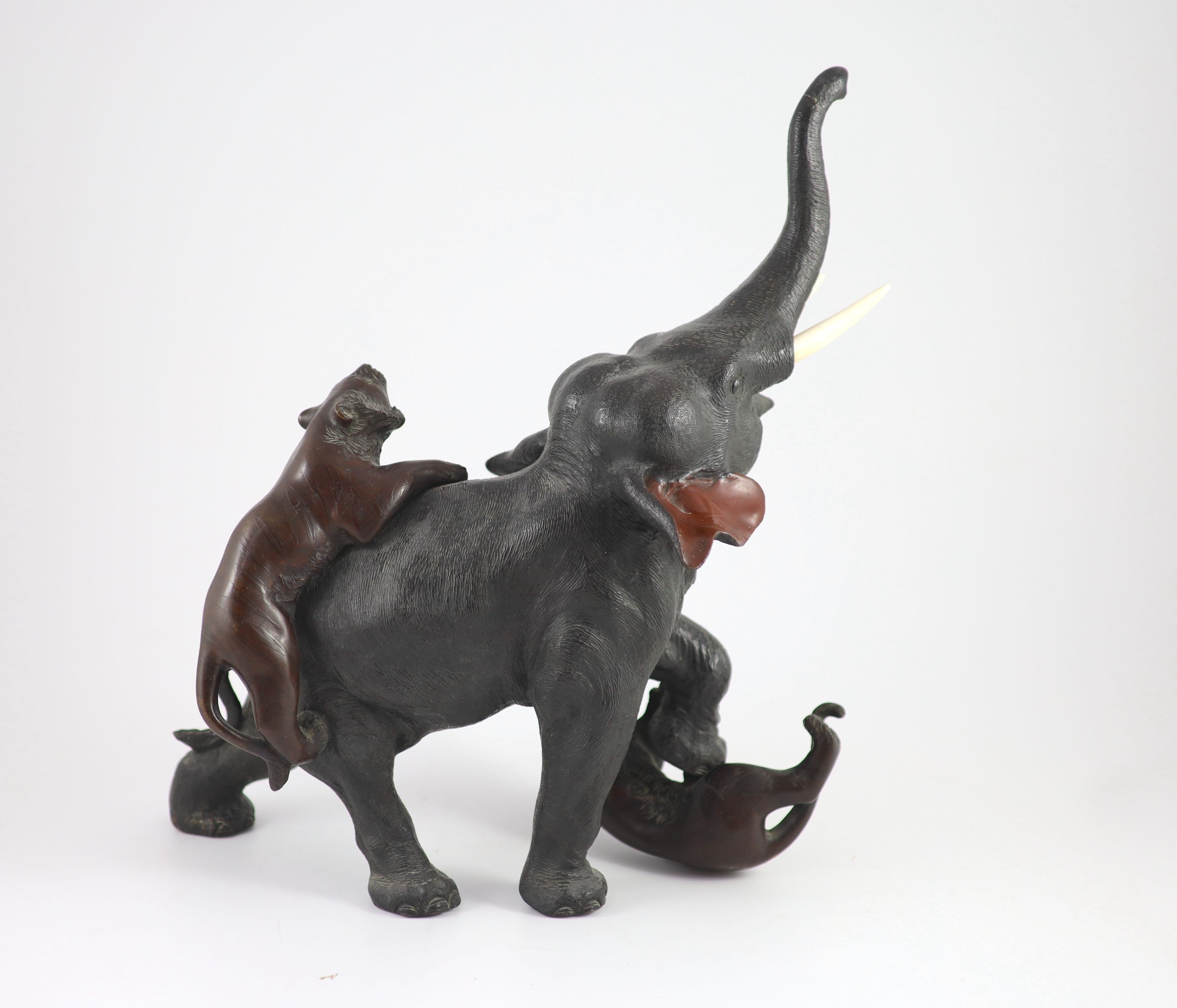 A good Japanese bronze elephant and tiger group, Meiji period signed Seiya saku, Total height 55cm and length 55cm including stand